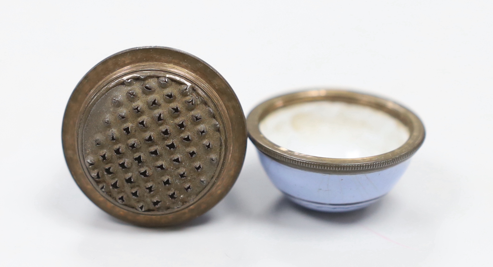 An egg shaped enamelled 19th century nutmeg grater with inscribed motto ‘May you be Happy’ 5cm high